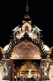 A serene temple entrance bathed in warm saffron light during sunset.