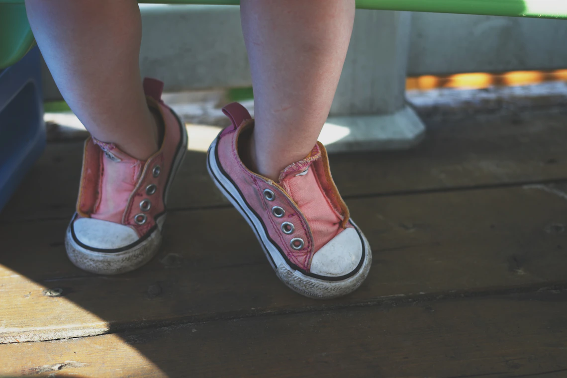 Toddler wearing casual shoes in a real childhood walking scene