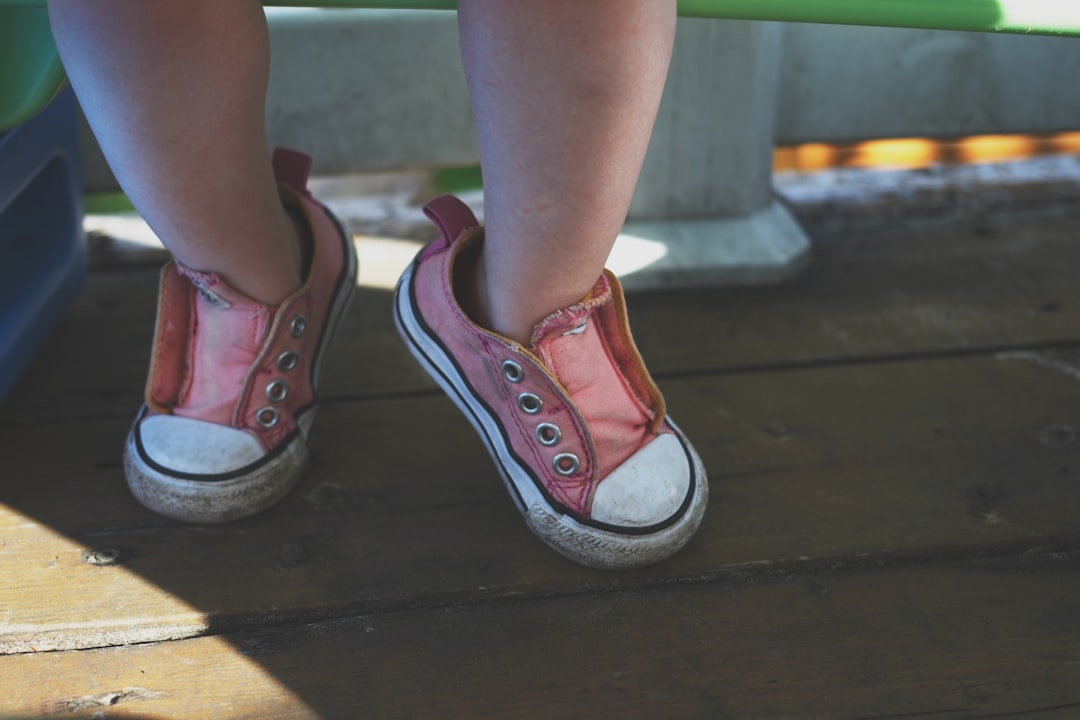 toddler wearing black-and-white low-top sneakers