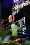 man making drink inside bar