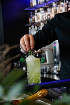 man making drink inside bar