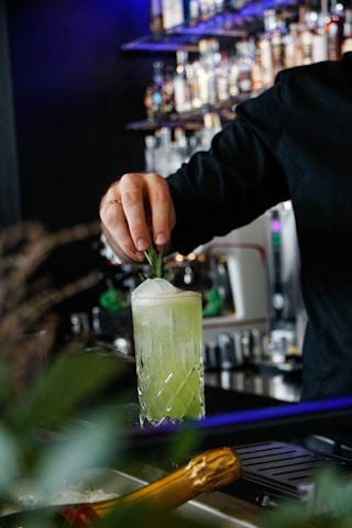 man making drink inside bar
