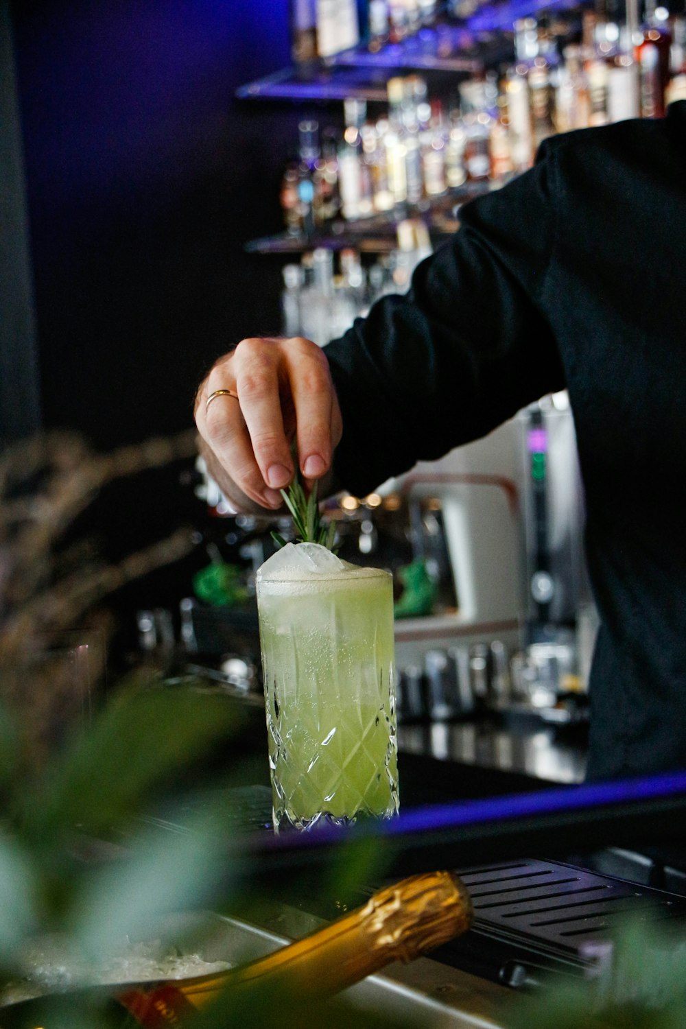 man making drink inside bar