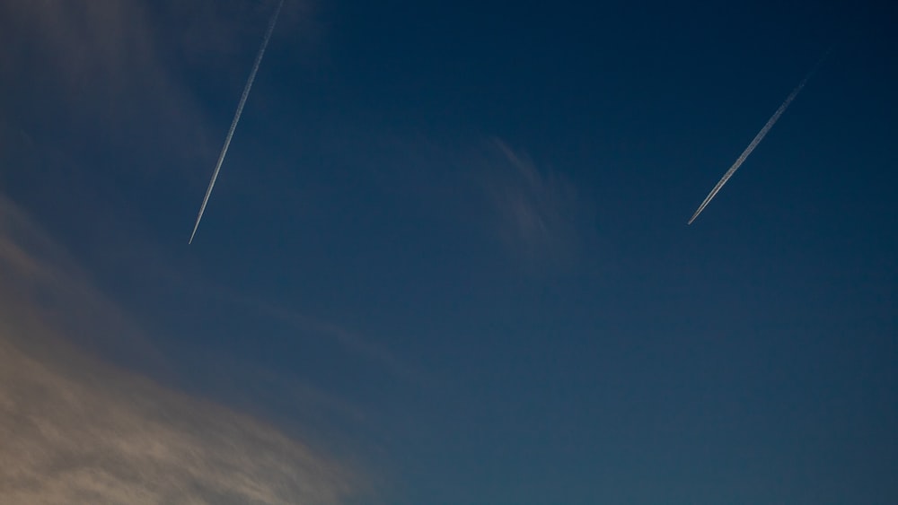 time lapse photography of two jets in the sky