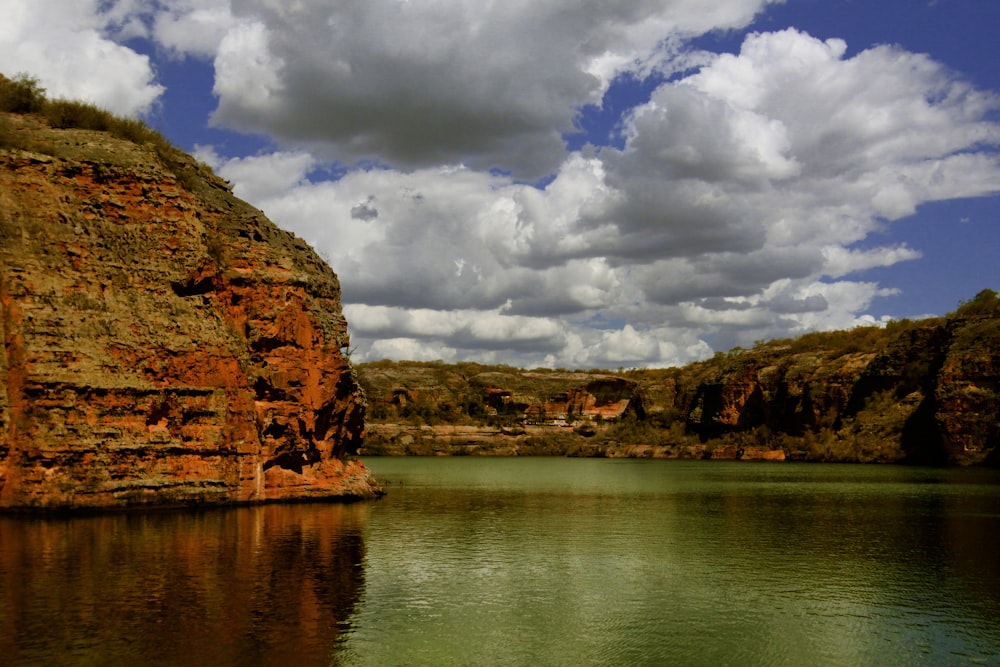 body of water near green mountains