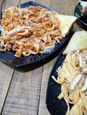 pasta dish on black plate