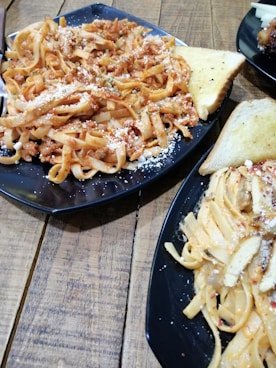 pasta dish on black plate