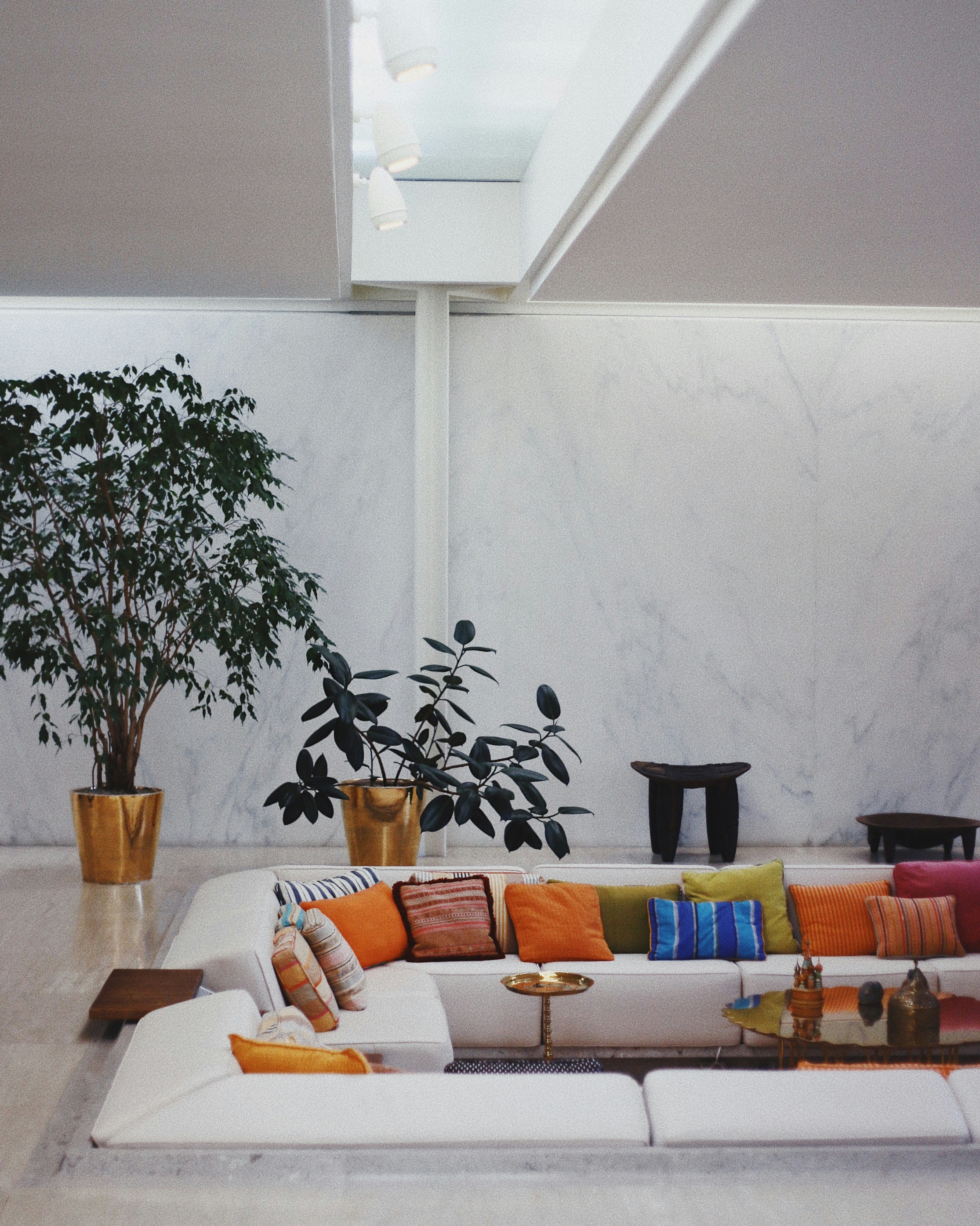 White Sectional Couch With Assorted Colored Throw Pillows On Top
