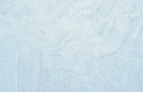 A marble texture with a smooth and subtle mix of light blue and white tones. The surface pattern consists of delicate, swirling veins and slight variations in color, resembling natural stone.
