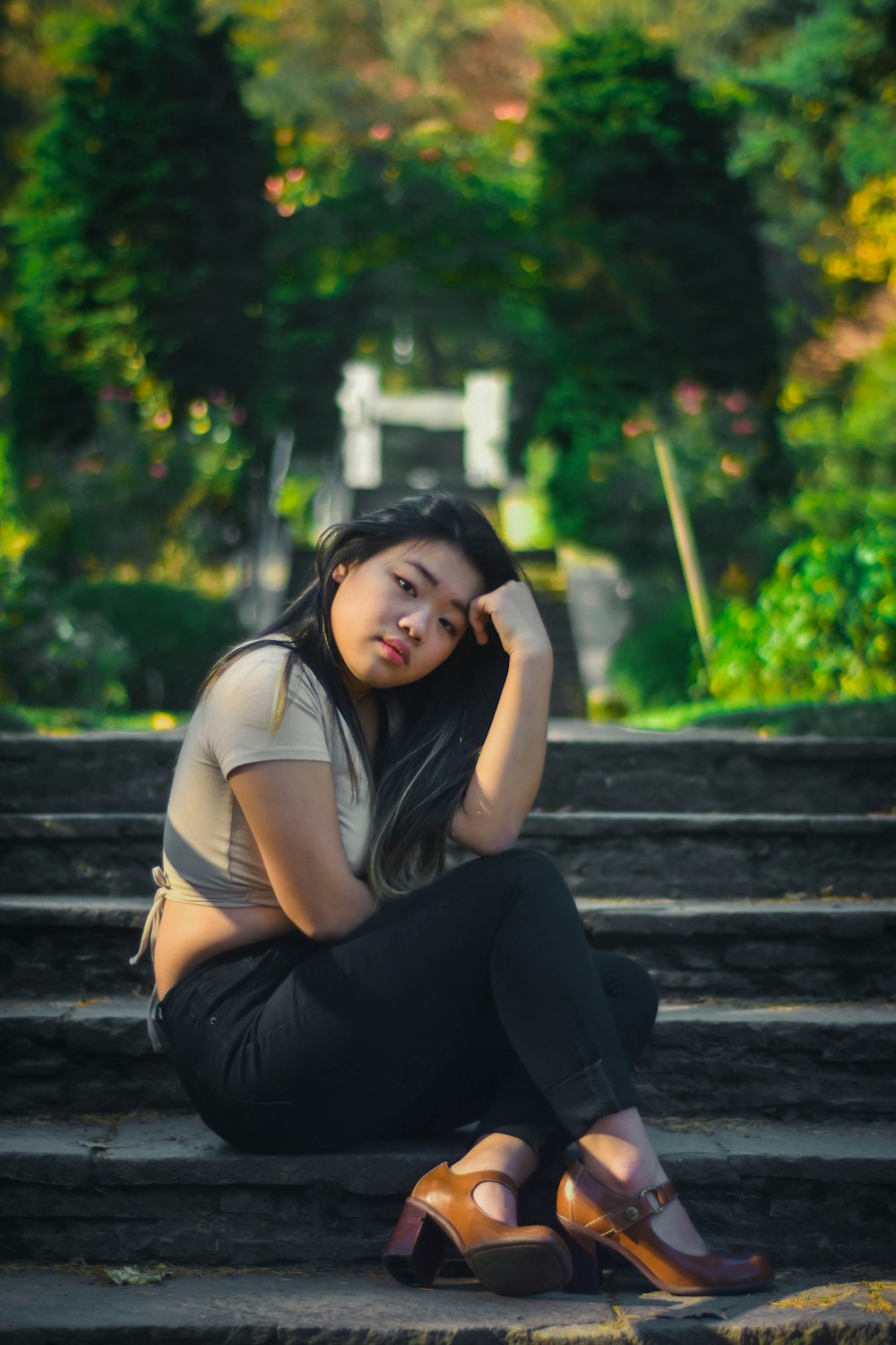 woman sitting on stairs during day