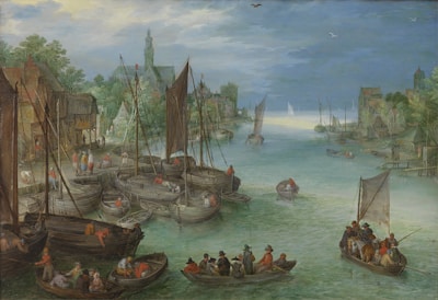 A bustling harbor scene with numerous sailing boats docked along the shore and people engaged in various activities both on the boats and on the land. The harbor is lined with rustic buildings, and a church with a tall steeple is prominent in the background. The sky is partly cloudy, and the water reflects the sky's colors. The overall setting is picturesque and lively with a sense of daily life in a historical maritime village.
