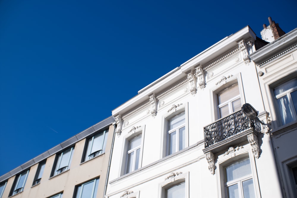 low-angle photo of white building under blue sky