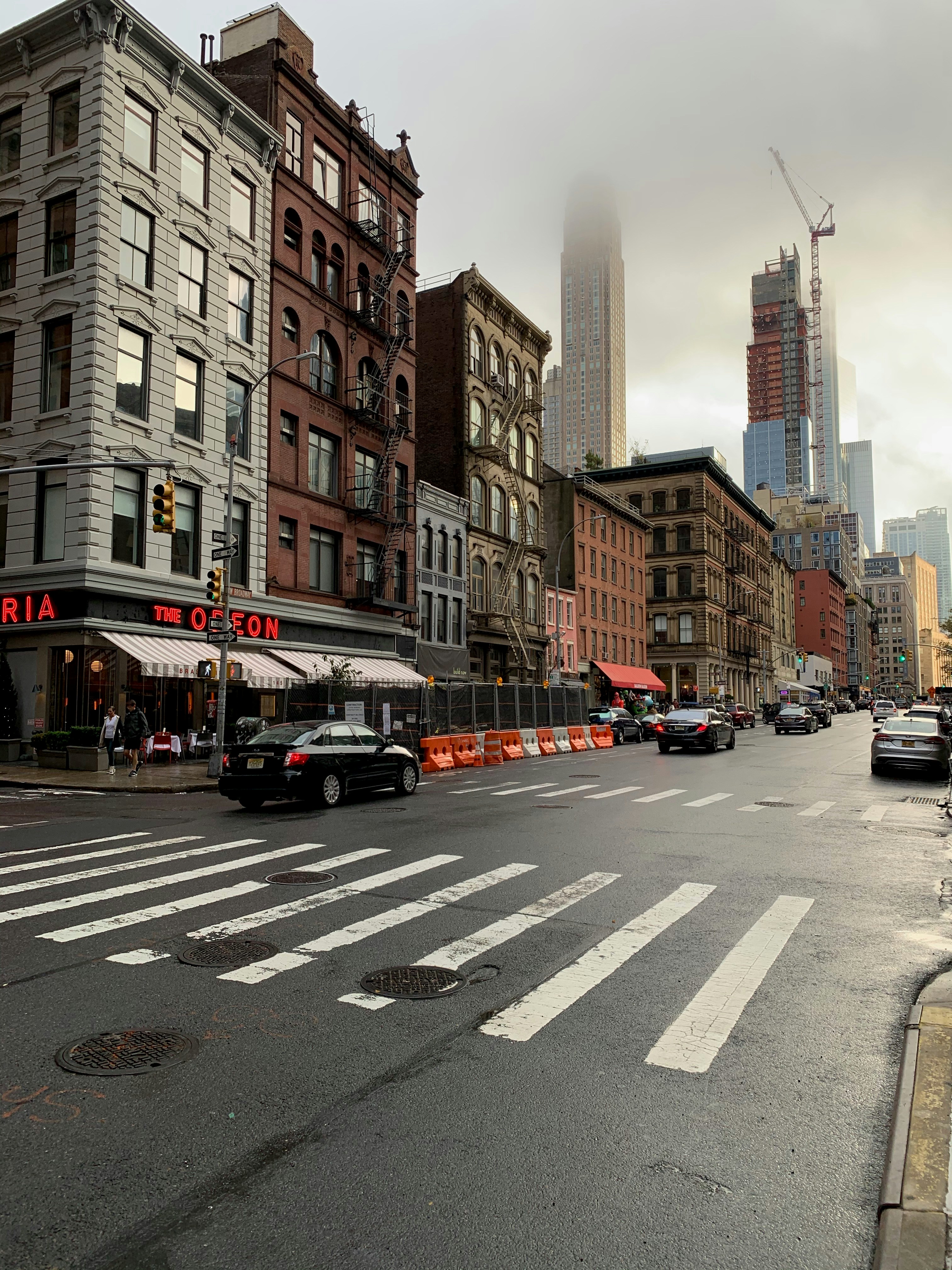 The Odeon restaurant on a Tribeca street in New York, with its red neon sign.