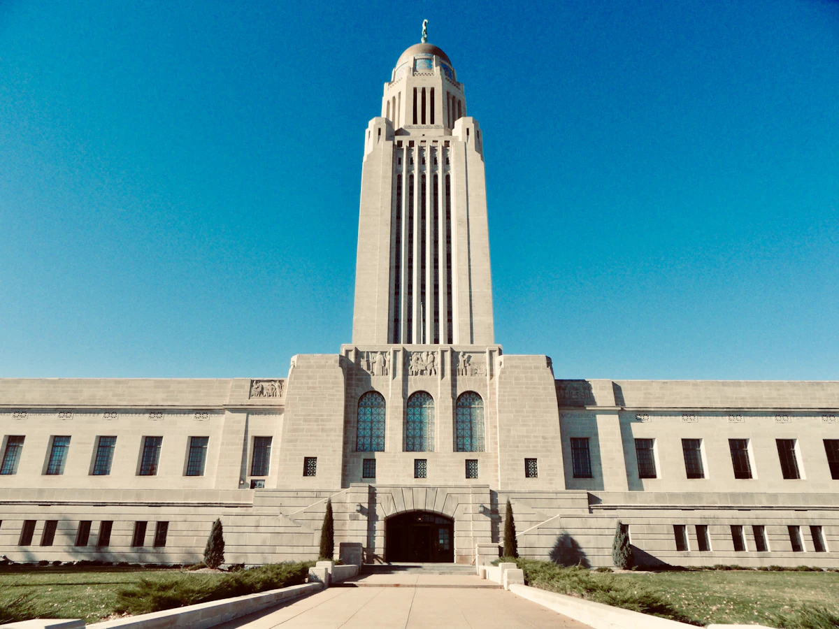 The Nebraska State Capitol in Lincoln under a clear blue sky