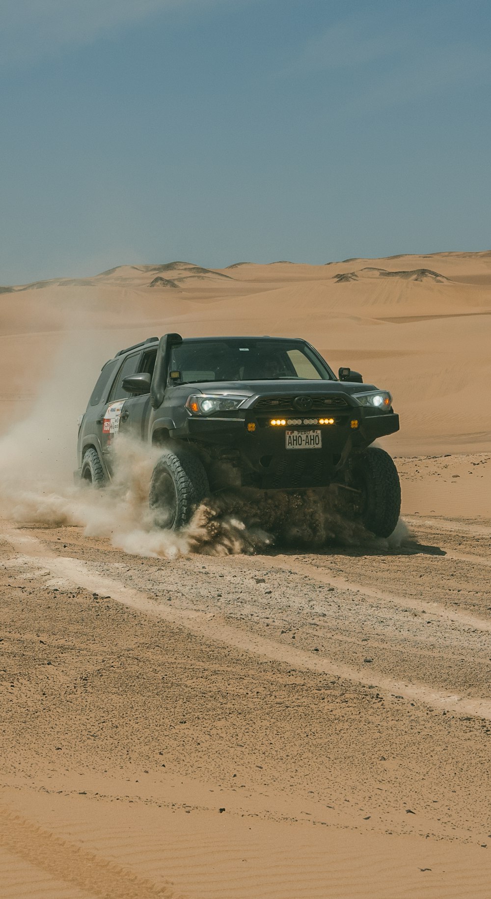 black SUV on the desert field