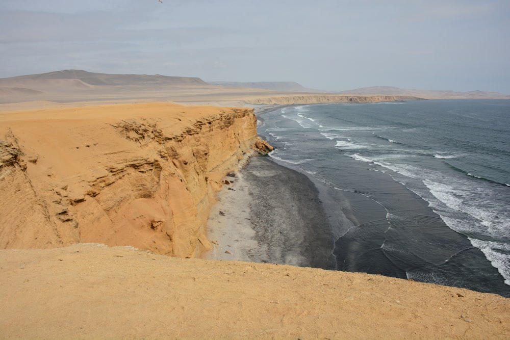 rock formations surrounded with body of water