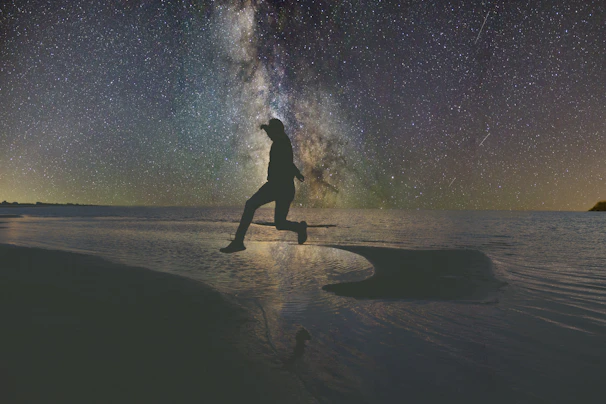 Me flying gracefully over a shimmering lake under a sky filled with twinkling stars.