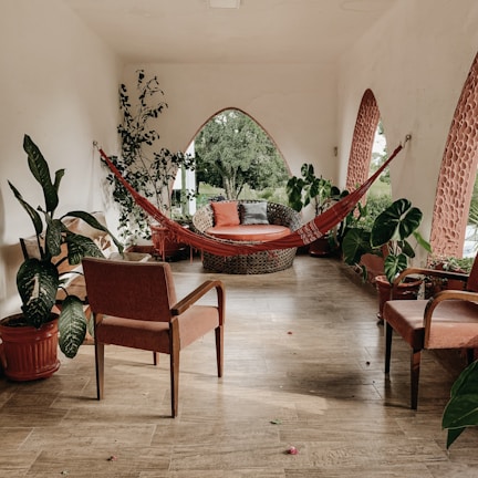 brown hammock near chairs and plant during daytime