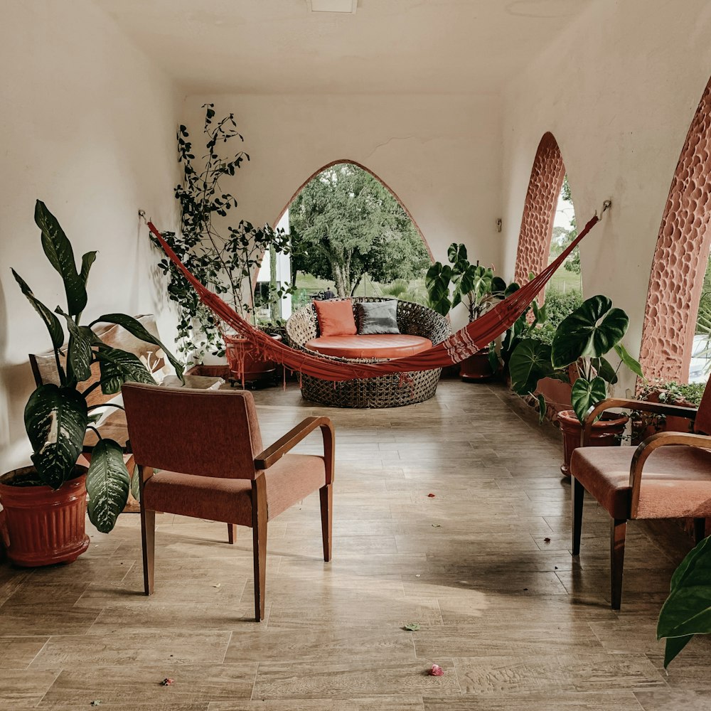 brown hammock near chairs and plant during daytime