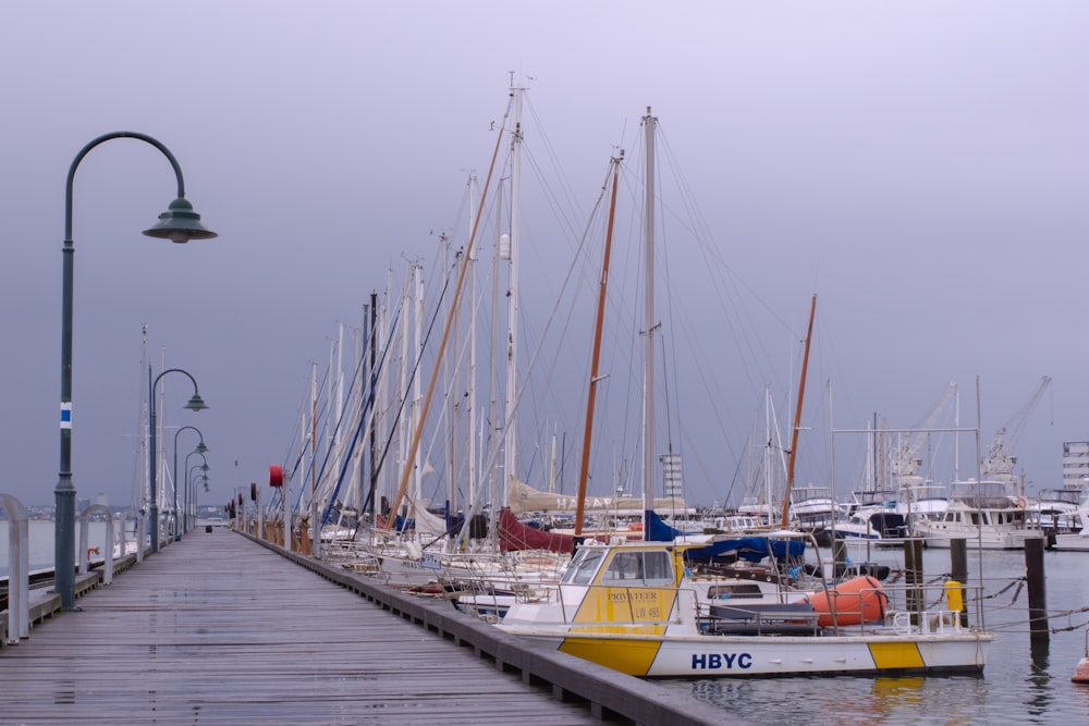 yacht docked beside boarwalk