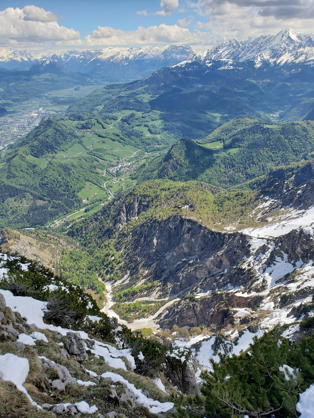 aerial view of snow-covered green grassy mountains during daytime