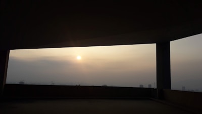 A serene sunset shot framed by a skylight, highlighting mood and tone.