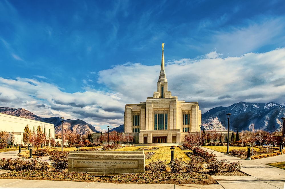 a church with a steeple and a fountain in front of it