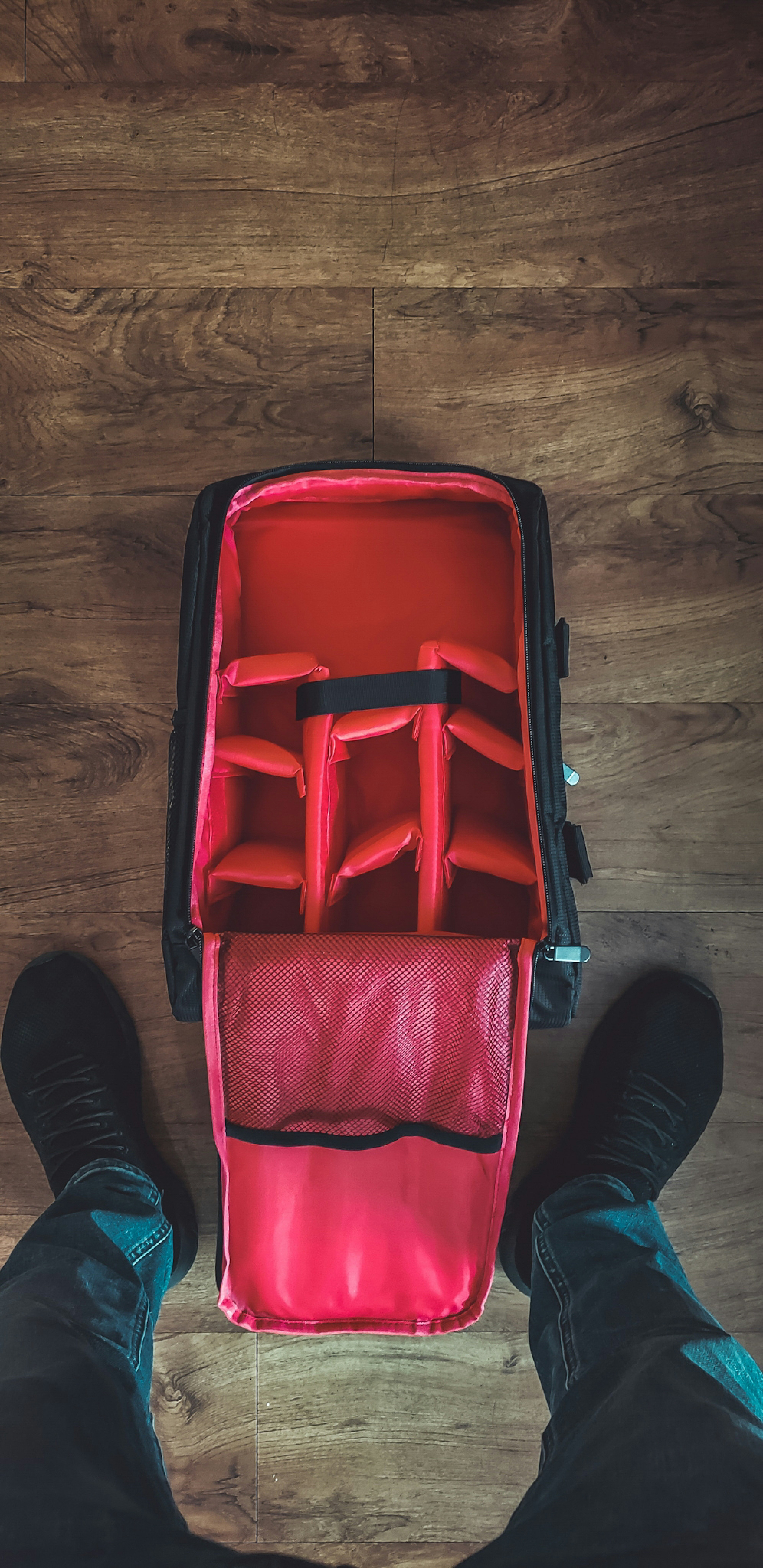 red and black bag on floor