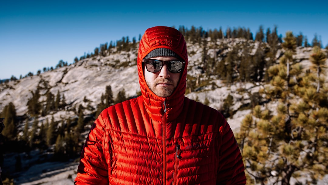 shallow focus photo of man in red full-zip hoodie