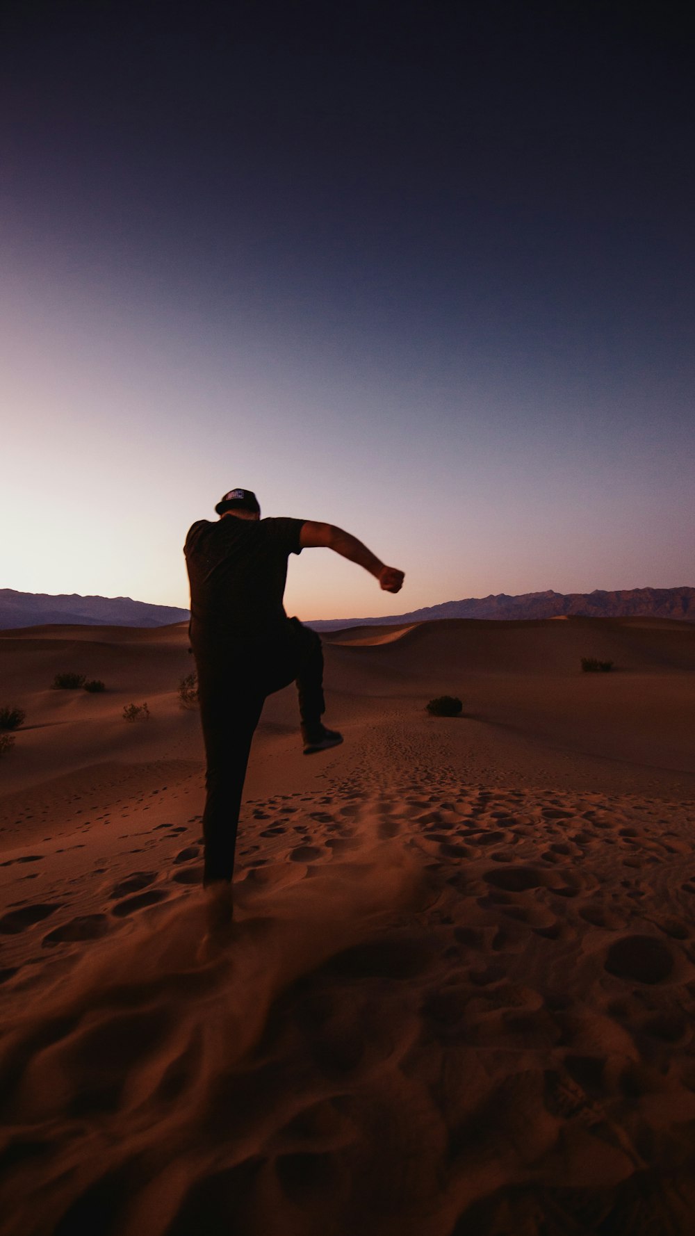 silhouette of person in desert during daytime