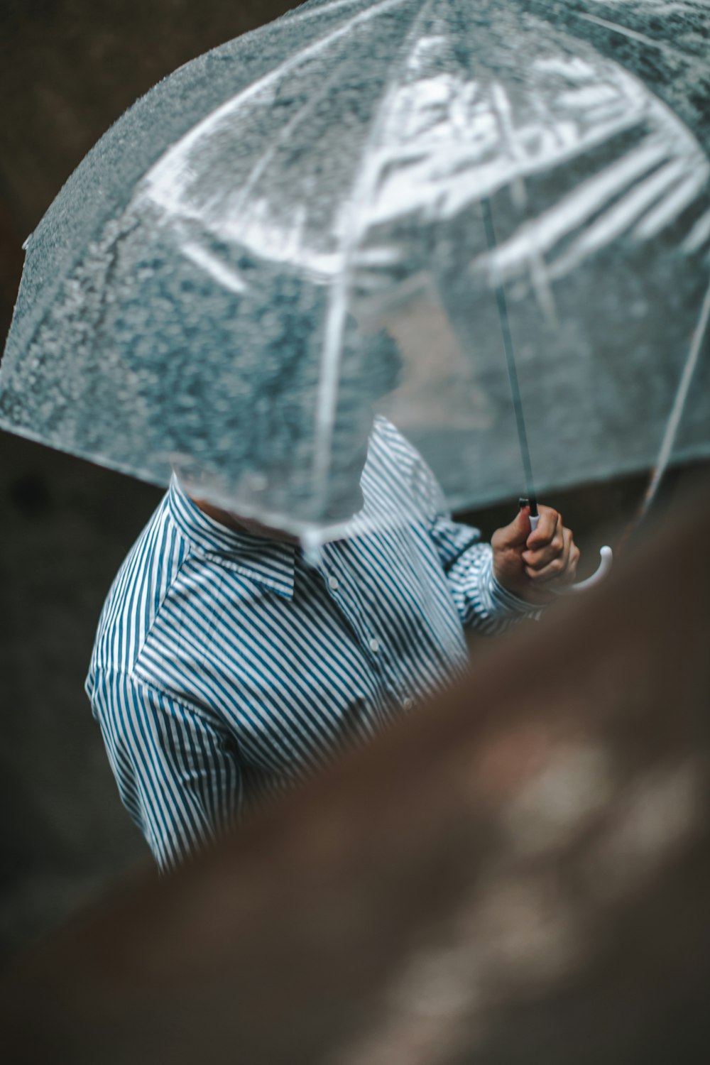 man under clear umbrella
