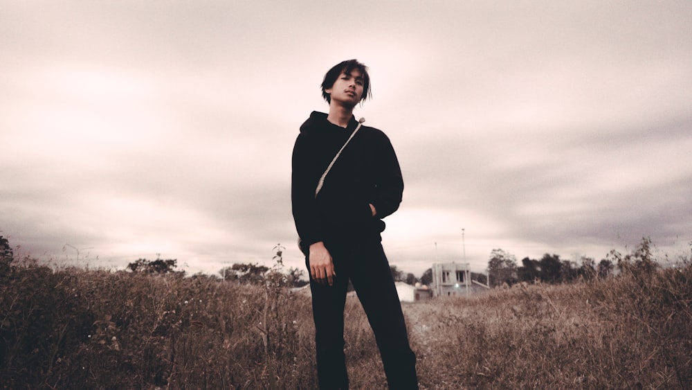 man in black hoodie in grass field