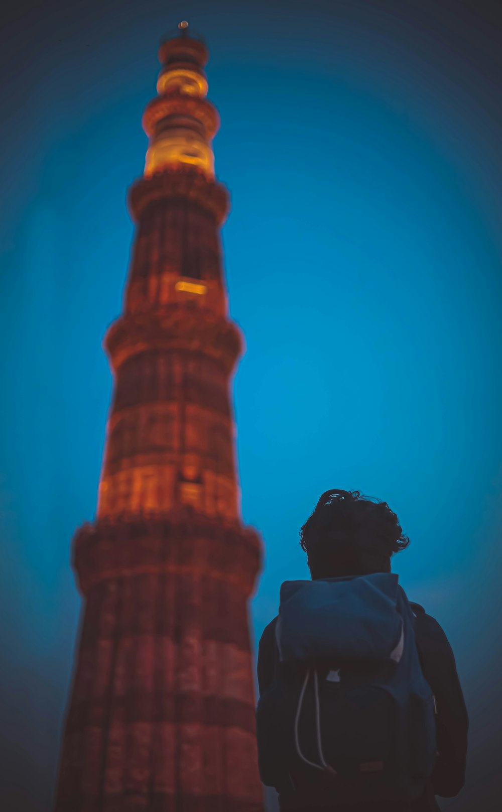 man with backpack near tower
