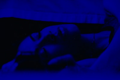 Close-up of a clinical hypnosis session with calming blue tones.