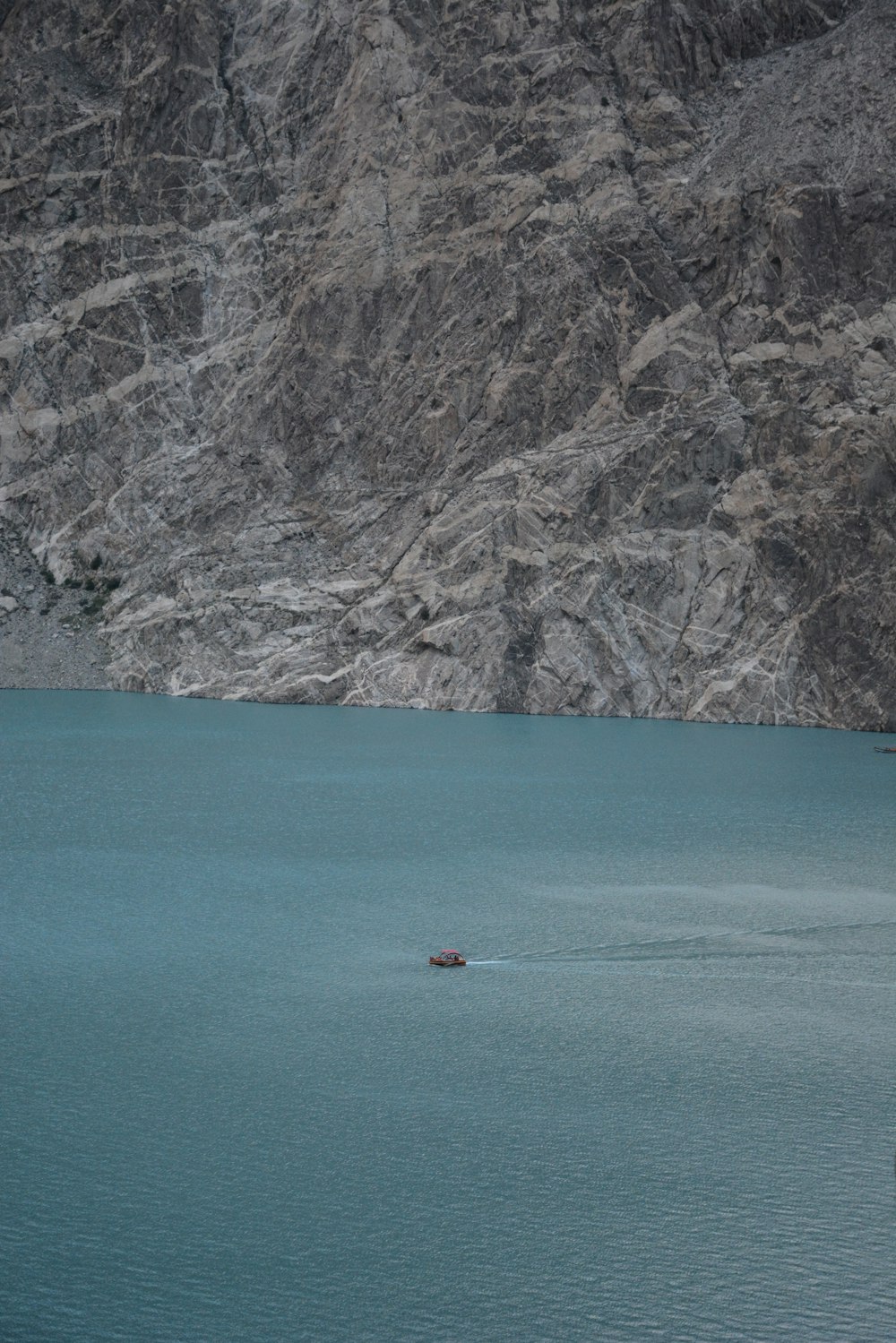 boat on lake near cliff