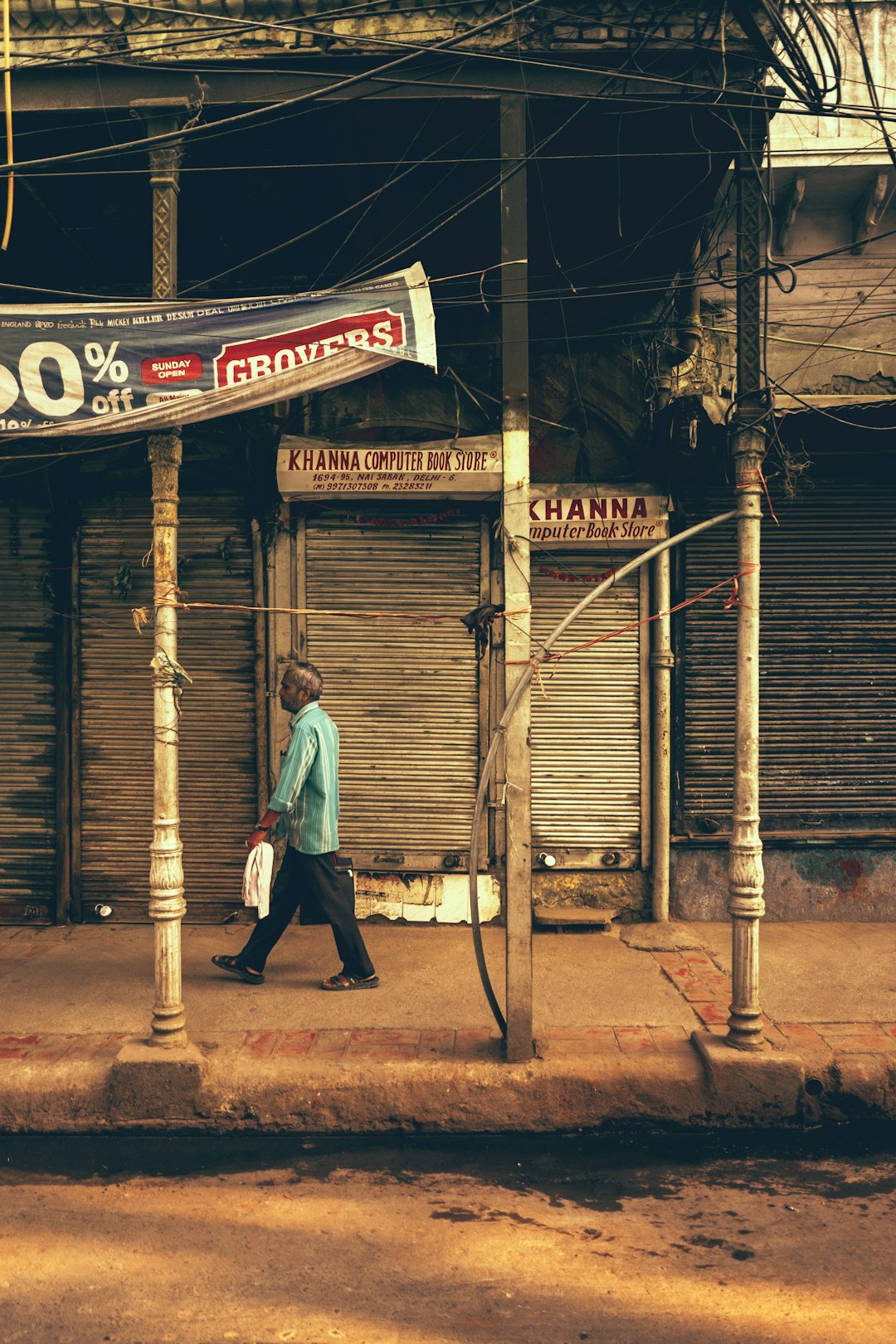 man walking beside building