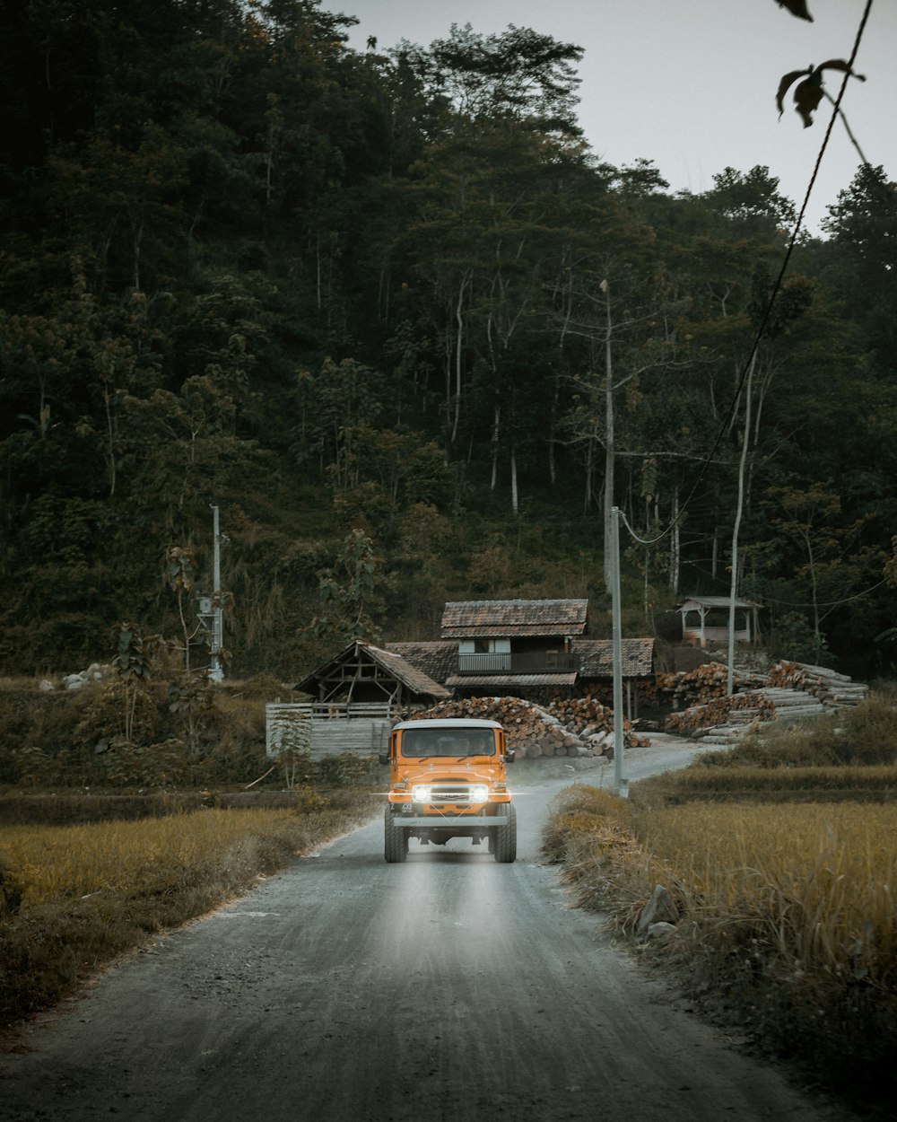 orange Jeep Wrangler on road