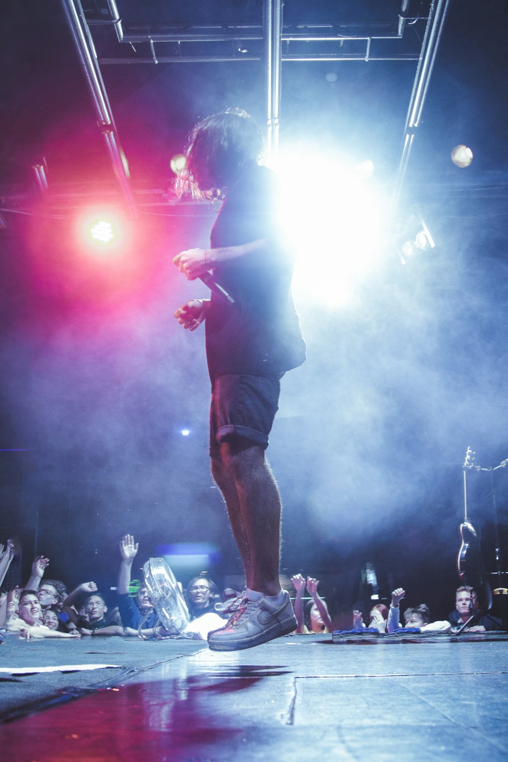 man jumping on stage