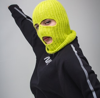 woman in black jacket with yellow ski mask