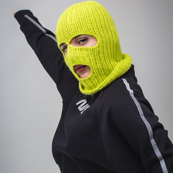 woman in black jacket with yellow ski mask