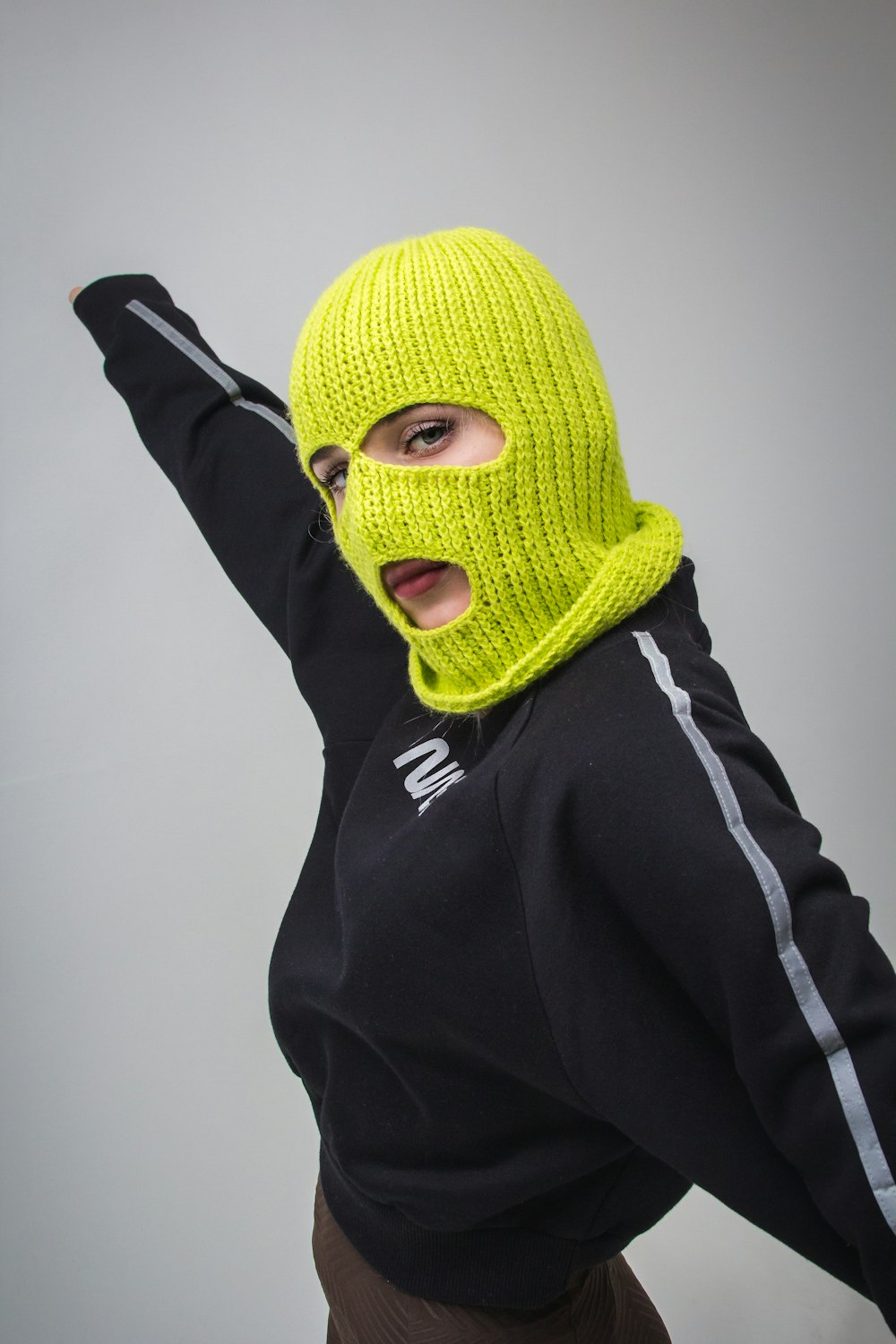 woman in black jacket with yellow ski mask