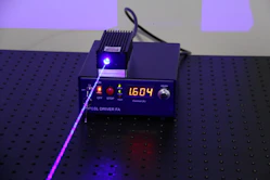 an electronic device with a purple light on top of it