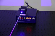 an electronic device with a purple light on top of it