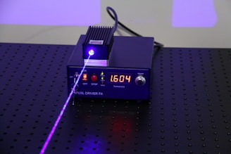 an electronic device with a purple light on top of it