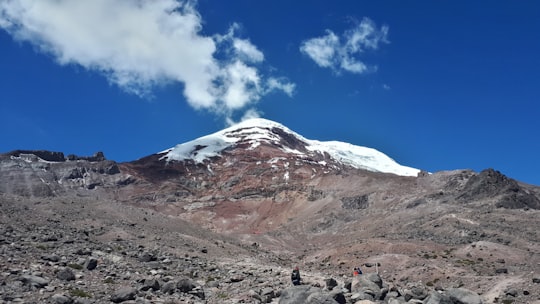 summit of mountain under white and blue sky in Reserva de Produccion Faunistica Chimborazo Ecuador