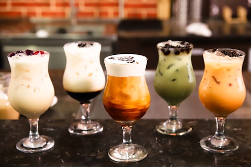 An assortment of milk tea drinks arranged aesthetically.