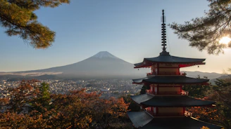 a pagoda with a mountain in the background
