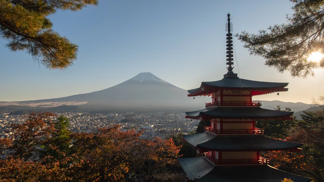 a pagoda with a mountain in the background