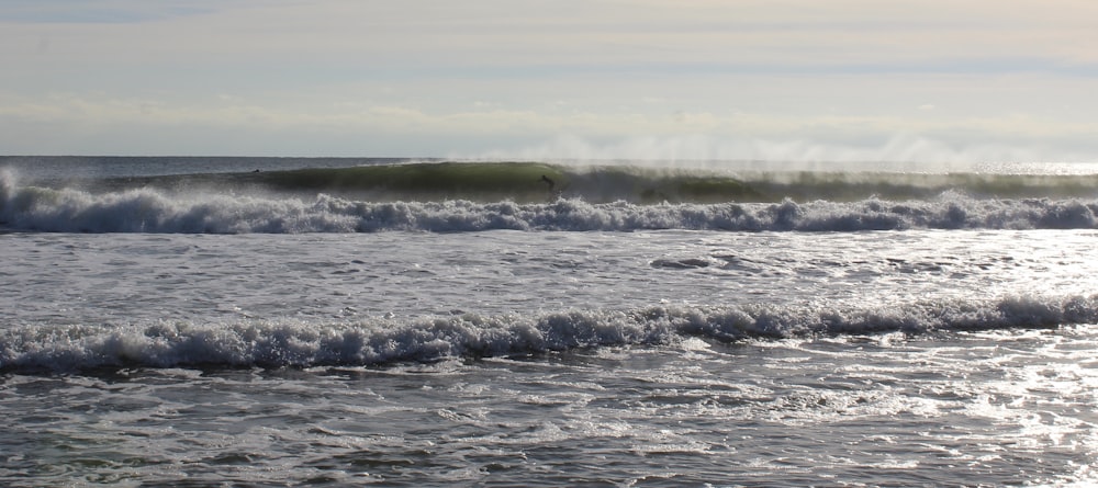 sea wave under white and blue sky during daytime