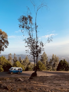 A scenic view of the Weppes countryside with an 'allo navettes' van driving along a quiet road.